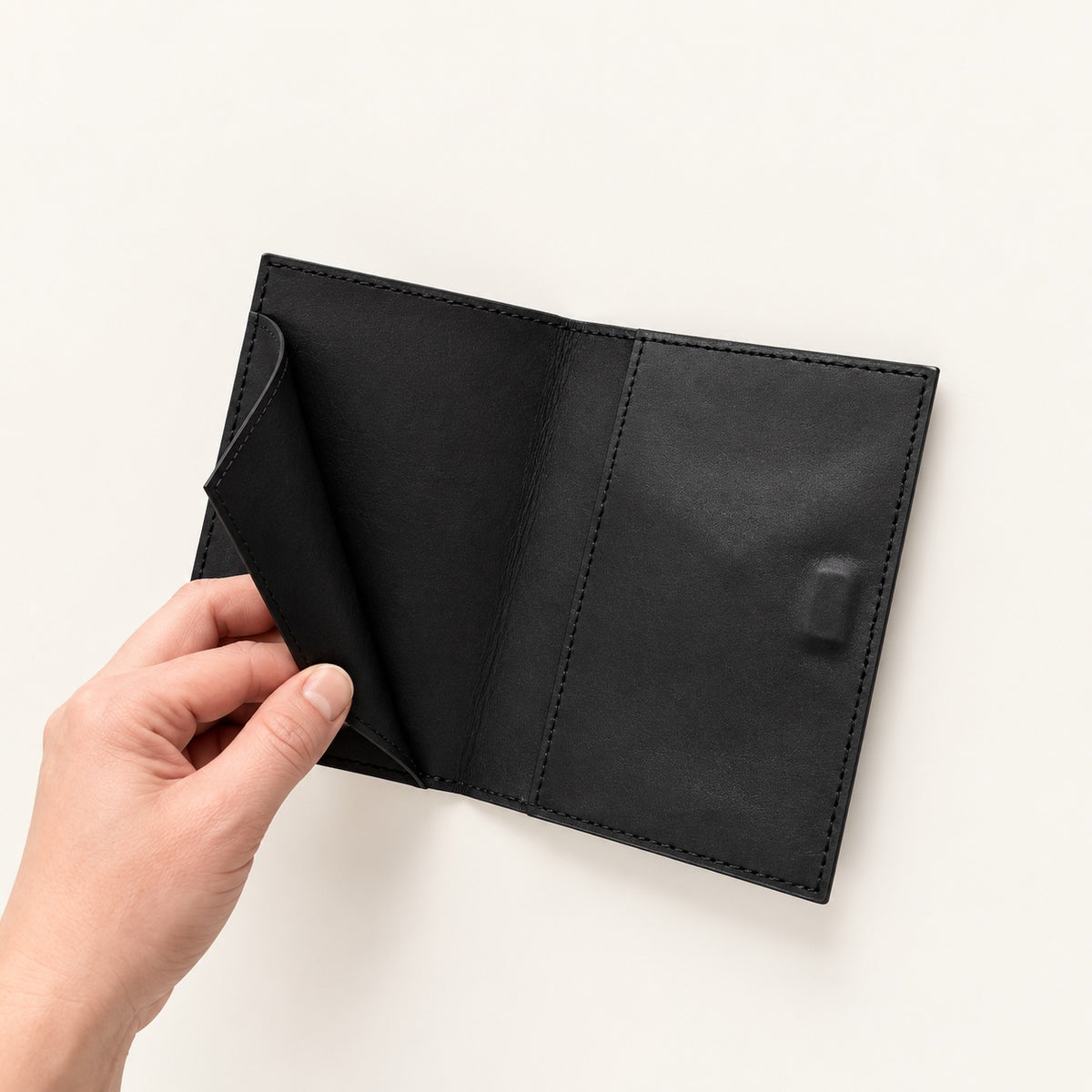 Black leather cardholder by Sirius Society – hand open view
